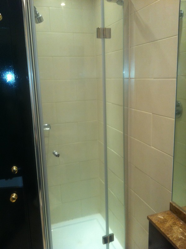 Frameless glass shower enclosure with chrome fittings in Lee